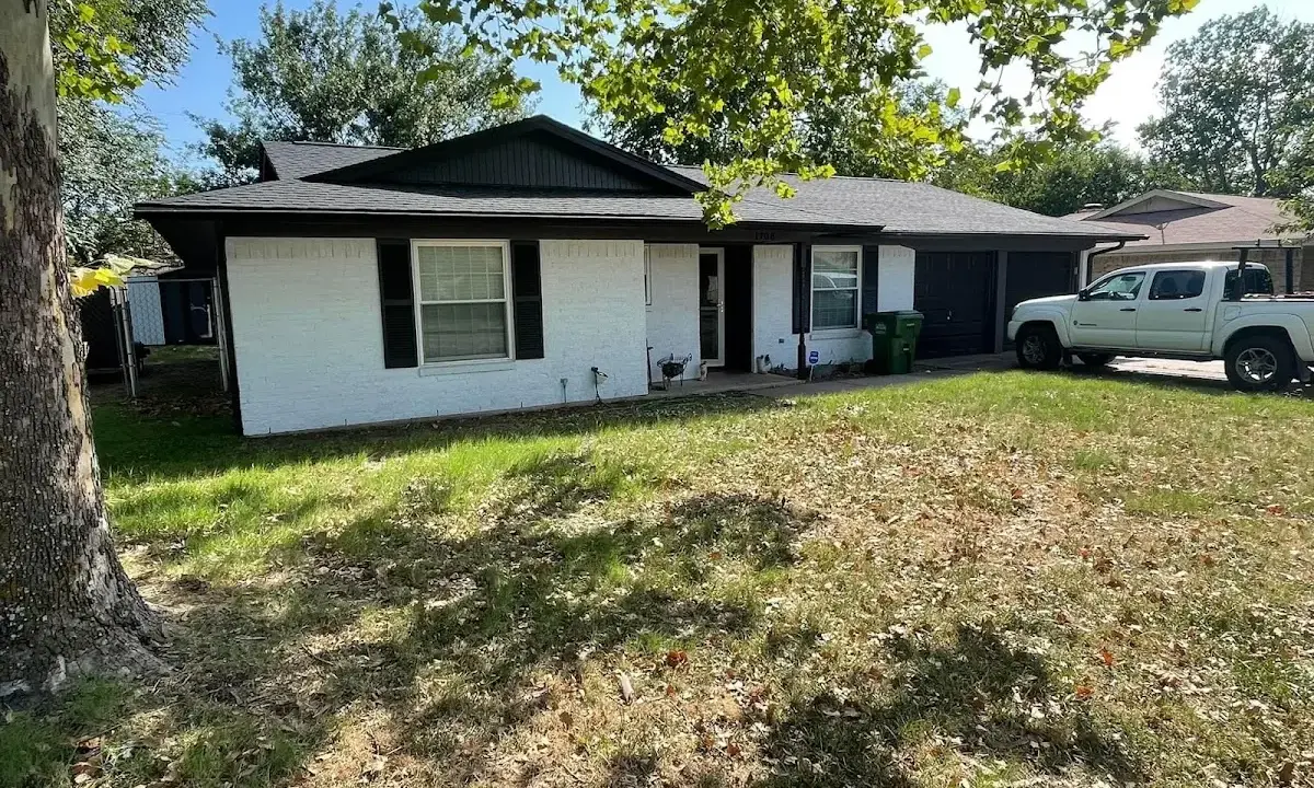 Professional roofing crew working on a residential roof in Plainfield